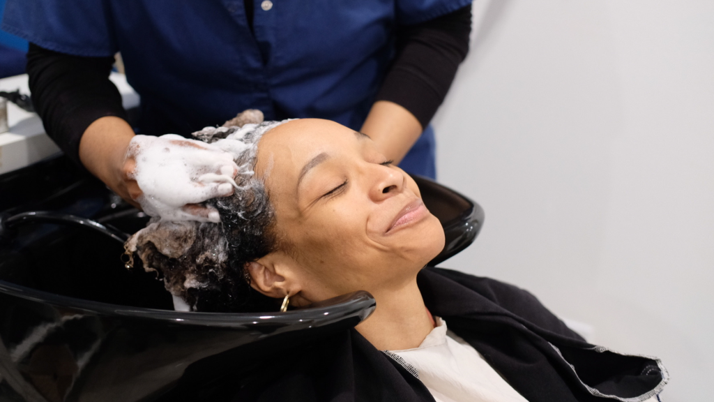 a woman being shampooed in a salon with Triple Threat